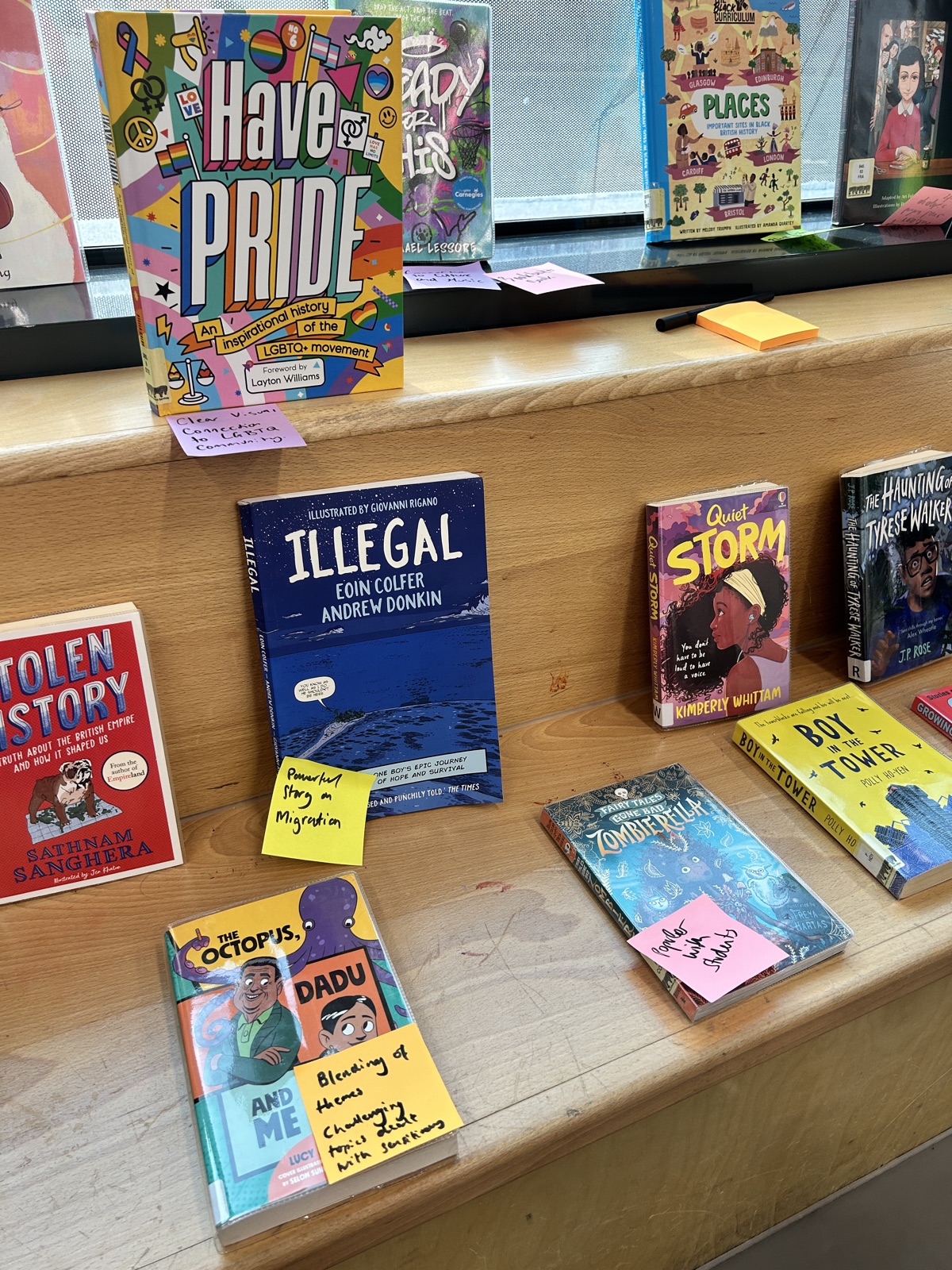A display of inclusive books with handwritten discussion notes
